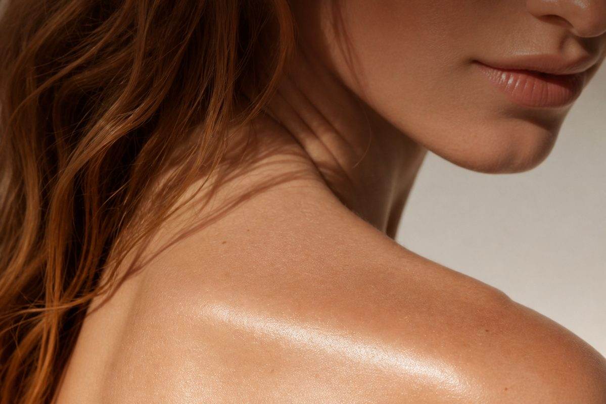 Woman showing glowing shoulder and neck skin — premium med spa aesthetic