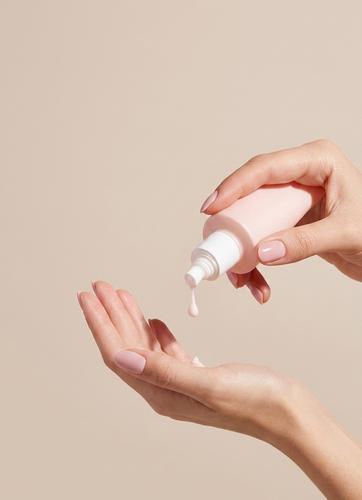 Skincare serum being applied to hand